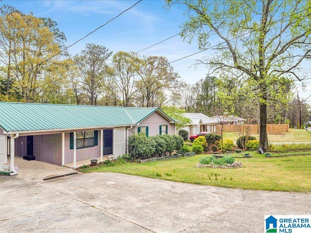 ranch-style house featuring a front yard and a carport