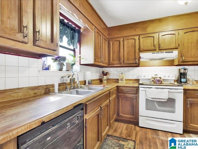 kitchen with black dishwasher, white electric stove, light wood-type flooring, backsplash, and sink