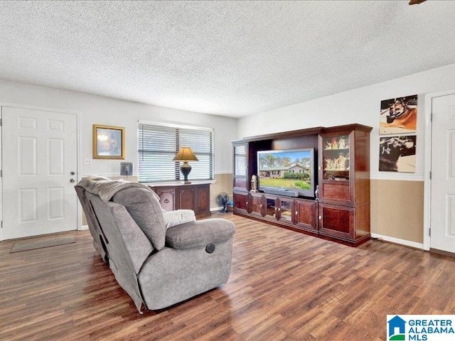 living room with dark wood-type flooring and a textured ceiling