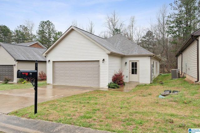 view of front of house with central air condition unit, a front lawn, and a garage