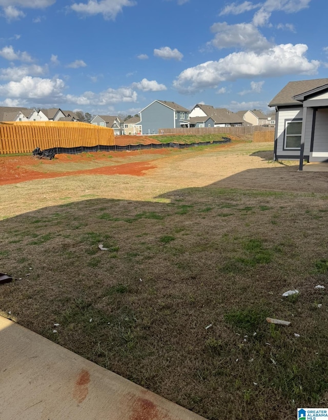view of yard with fence and a residential view