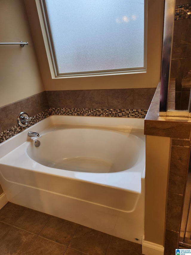 bathroom with tile floors and a bathtub