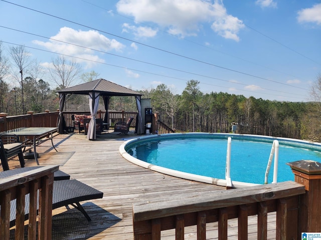 view of swimming pool with a gazebo and a wooden deck