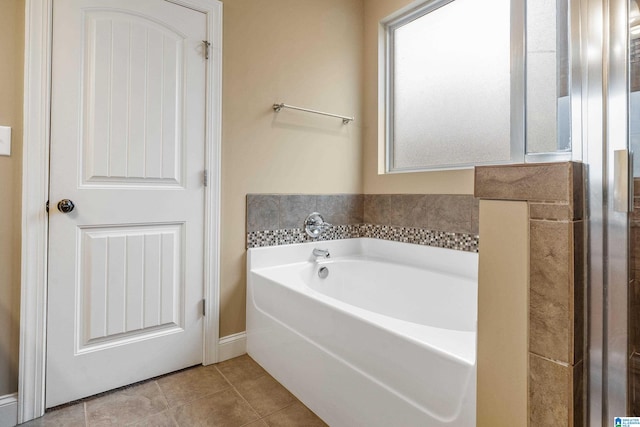 bathroom featuring a tub and tile floors