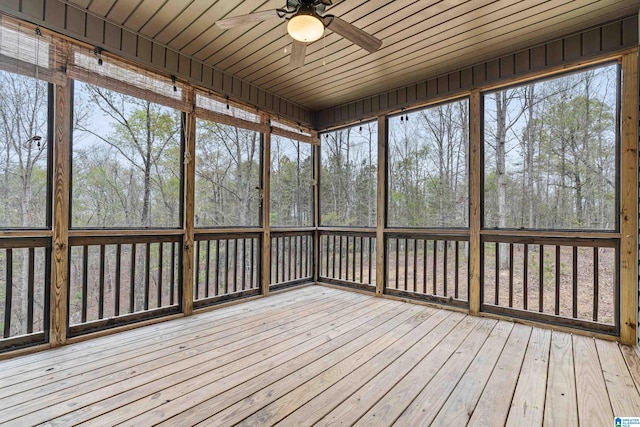 unfurnished sunroom featuring wooden ceiling and ceiling fan