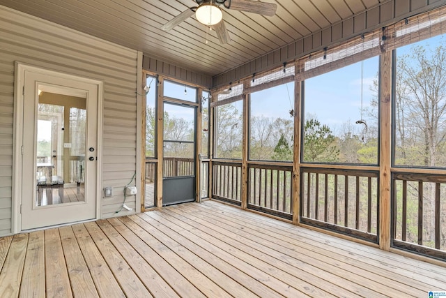 unfurnished sunroom with ceiling fan