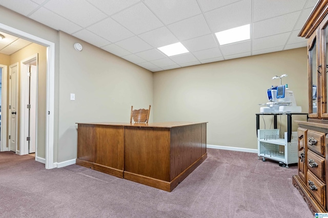 office featuring a paneled ceiling and dark colored carpet