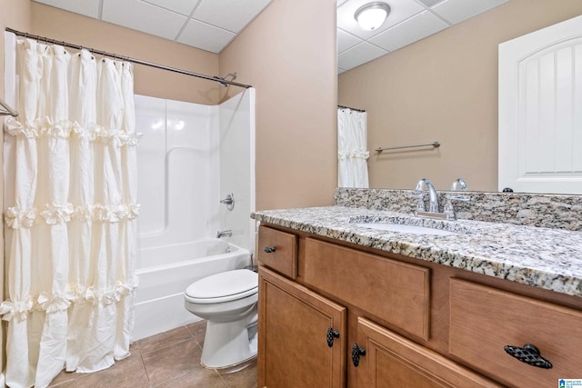 full bathroom with toilet, vanity, a paneled ceiling, shower / bathtub combination with curtain, and tile floors