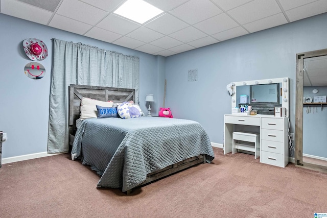 bedroom featuring a drop ceiling and carpet flooring