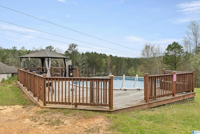 view of pool featuring a wooden deck, a lawn, and a gazebo