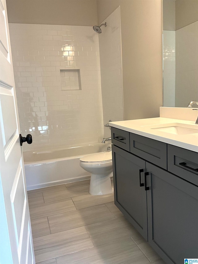 full bath featuring tub / shower combination, vanity, and toilet