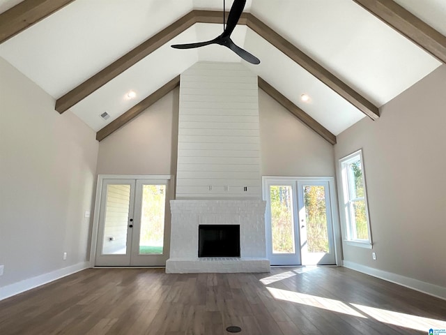 unfurnished living room with a fireplace, beam ceiling, and baseboards