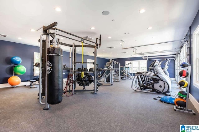 exercise room with a garage, baseboards, and recessed lighting