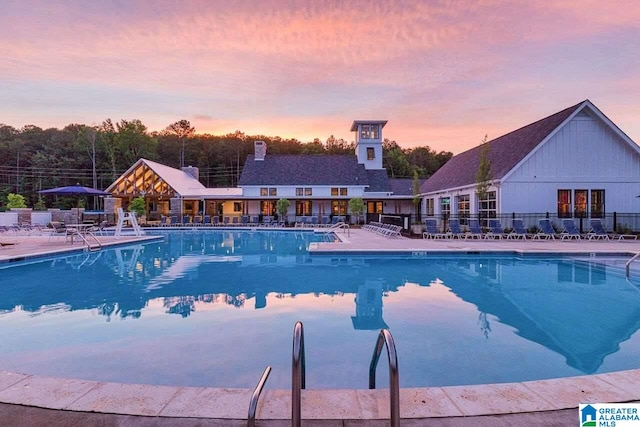 community pool featuring a patio and fence