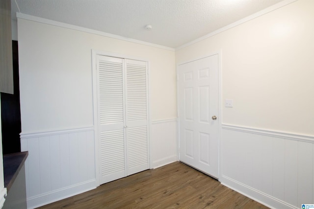 unfurnished bedroom with a closet and dark wood-type flooring