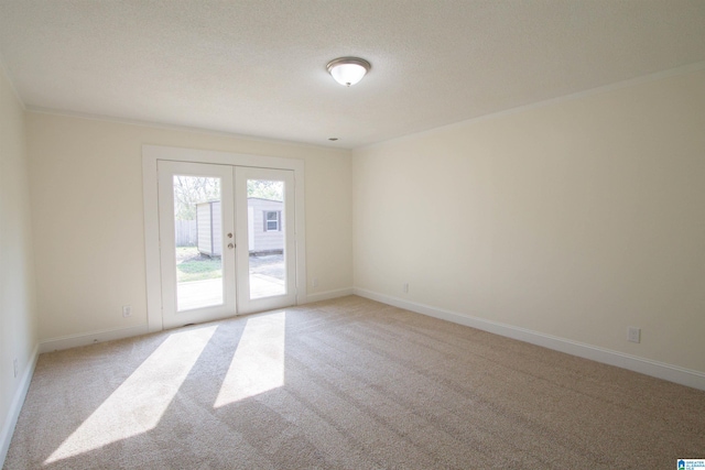 unfurnished room featuring light colored carpet and french doors