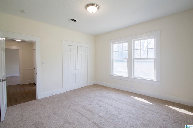 unfurnished bedroom featuring a closet and light hardwood / wood-style floors