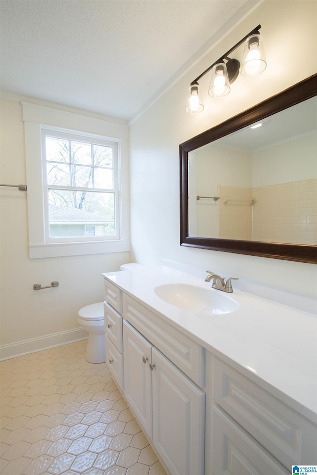 bathroom with toilet, tile flooring, ornamental molding, and vanity