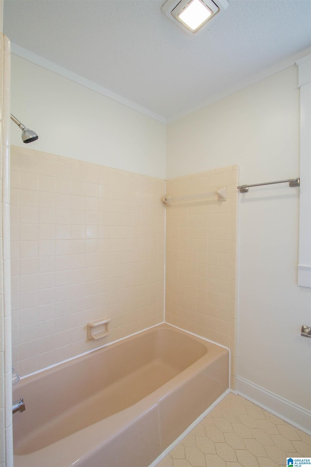 bathroom featuring tiled shower / bath combo, a textured ceiling, and tile flooring