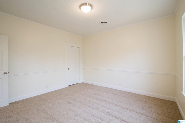 carpeted spare room with crown molding