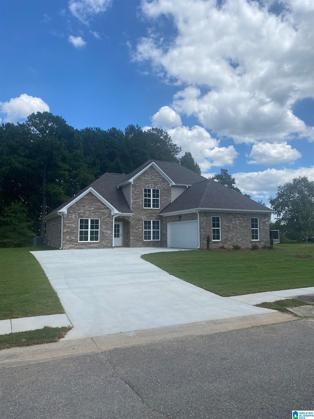 view of front facade with a garage, concrete driveway, and a front yard