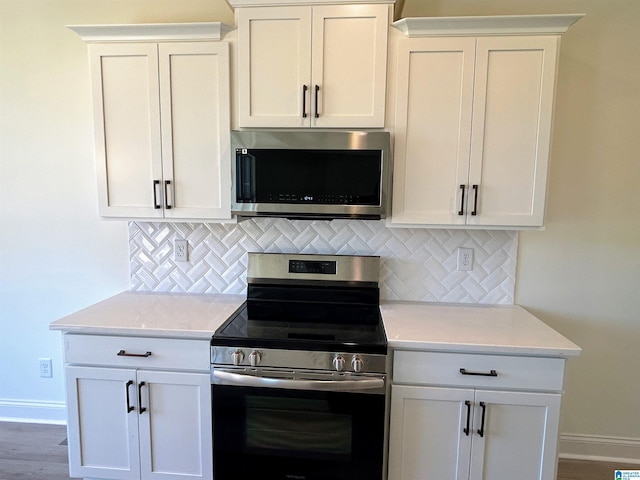 kitchen featuring tasteful backsplash, appliances with stainless steel finishes, and light countertops