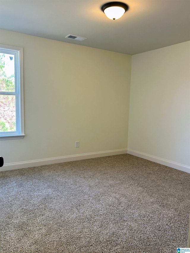 unfurnished room featuring visible vents, baseboards, and carpet floors