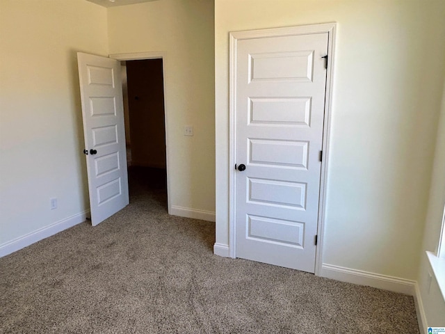 unfurnished bedroom with baseboards and carpet floors