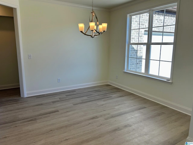 unfurnished room with crown molding, baseboards, and wood finished floors