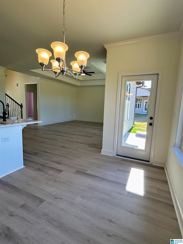 interior space featuring stairway, wood finished floors, baseboards, and a chandelier