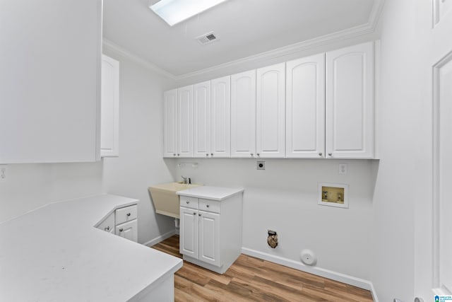 laundry room with electric dryer hookup, light hardwood / wood-style flooring, crown molding, and hookup for a gas dryer