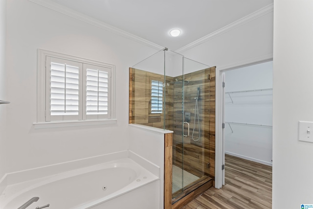 bathroom featuring hardwood / wood-style flooring, crown molding, and independent shower and bath