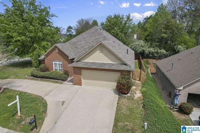 view of front of house featuring a garage and a front lawn