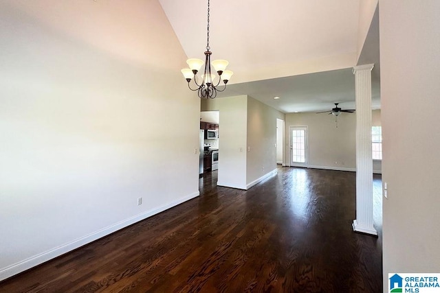 spare room with ceiling fan with notable chandelier, ornate columns, and dark hardwood / wood-style flooring