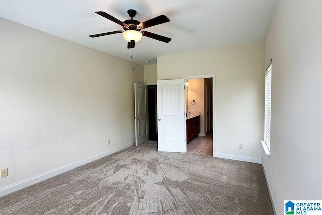 unfurnished bedroom featuring carpet flooring, ceiling fan, and ensuite bathroom