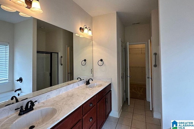 bathroom with a shower with shower door, tile floors, and double vanity