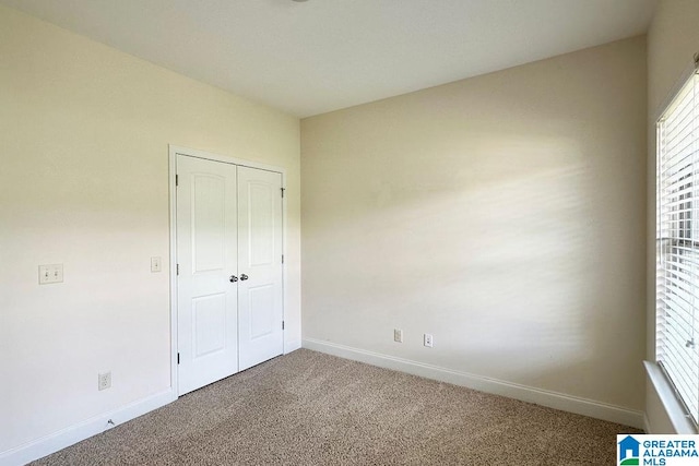 unfurnished bedroom with a closet and carpet floors