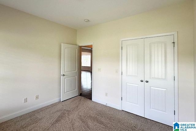 unfurnished bedroom with carpet flooring and a closet