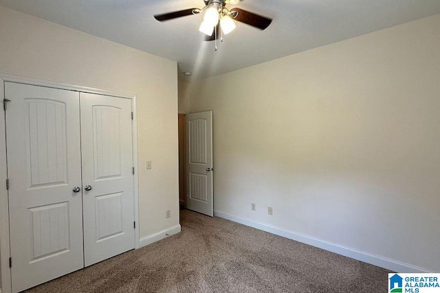 unfurnished bedroom with a closet, ceiling fan, and carpet flooring