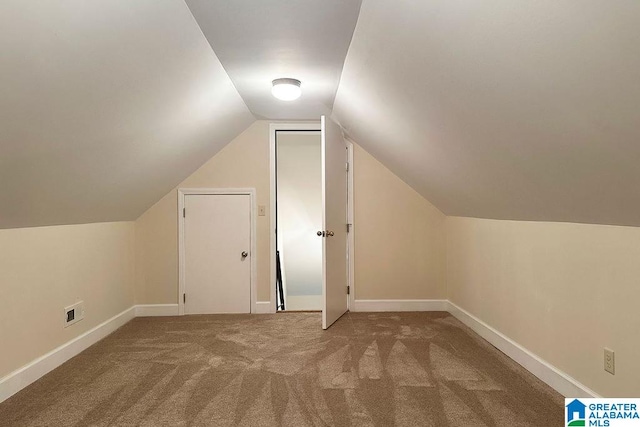 additional living space with vaulted ceiling and carpet floors