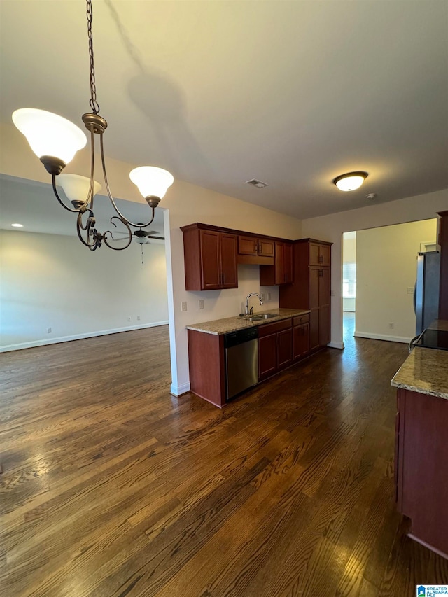 kitchen with sink, stainless steel appliances, dark hardwood / wood-style floors, pendant lighting, and an inviting chandelier