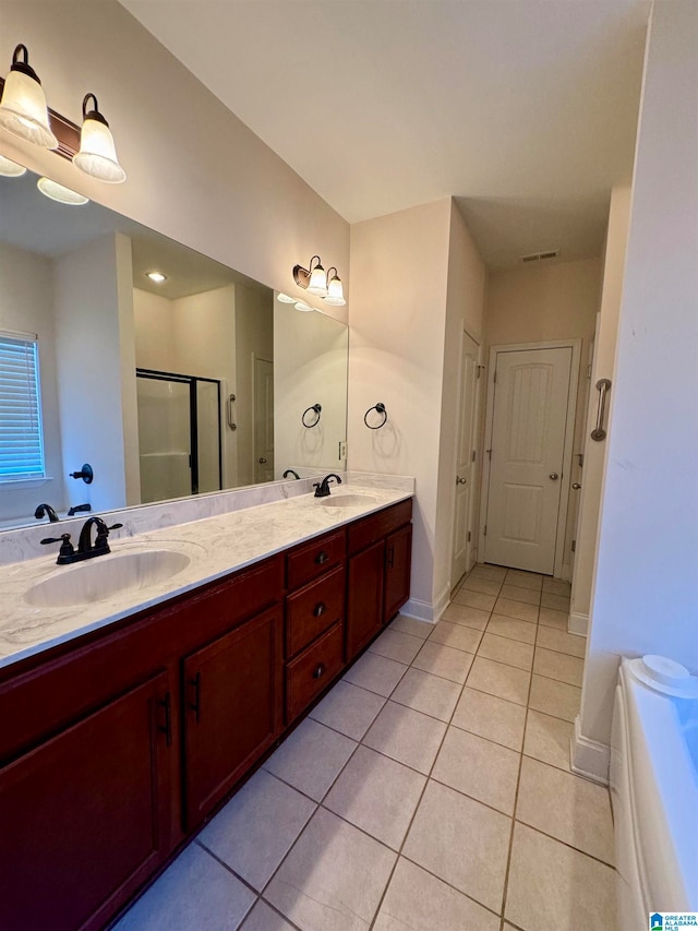 bathroom with tile flooring, oversized vanity, an enclosed shower, and double sink