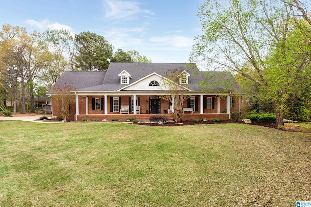 view of front of property featuring covered porch and a front yard