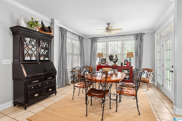 dining space featuring plenty of natural light, light tile floors, ornamental molding, and ceiling fan