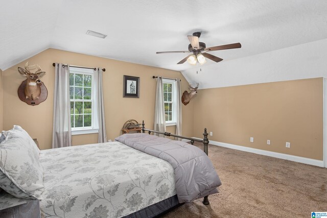 carpeted bedroom featuring ceiling fan and vaulted ceiling