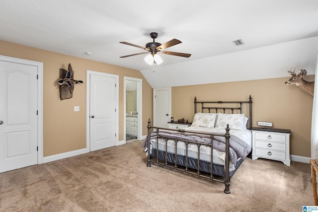carpeted bedroom featuring ensuite bath, ceiling fan, and lofted ceiling