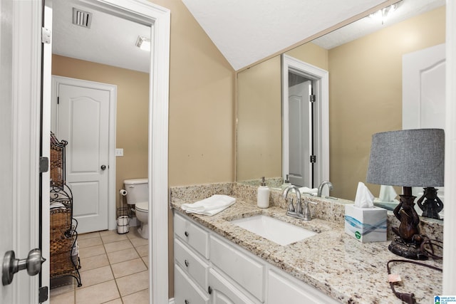 bathroom featuring tile floors, toilet, and vanity