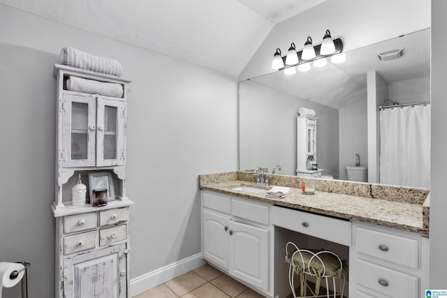 bathroom featuring tile floors, toilet, vanity, and lofted ceiling