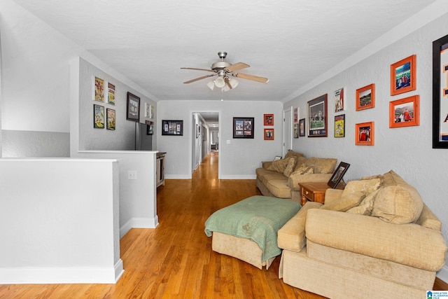 living room with ceiling fan and hardwood / wood-style floors