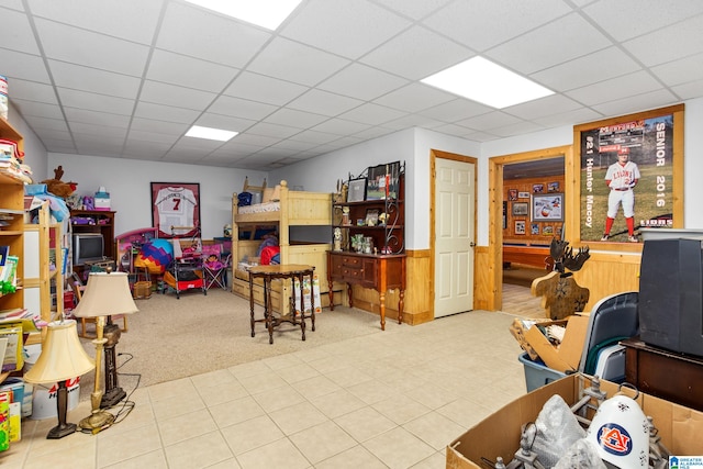 playroom with a drop ceiling and light carpet